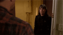 a woman in a black coat stands next to a man