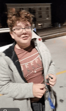 a young man wearing glasses and a shirt that says jeep on it
