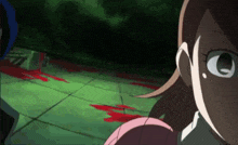 a girl in a pink shirt is standing in a dark room with blood on the floor