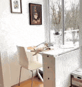 a cat is laying on a desk with a picture on the wall above it