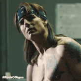 a shirtless man with a bandana on his head and the hashtag #rockofages on the bottom right