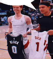 a basketball player holding up a jersey that says dick on it
