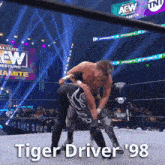 a wrestling match with the words tiger driver 98 written on the bottom