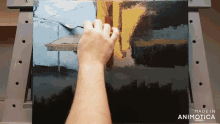 a hand is holding a spoon over a painting with the words made in animatica below it