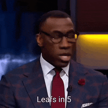 a man in a suit and tie is talking about leafs in 5