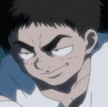 a close up of a man 's face with a smirk on his face