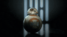 a bb-8 star wars robot is sitting on a table in a dark room