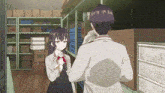 a man and a girl are standing in a warehouse talking to each other