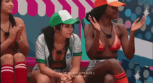 a group of women are sitting in front of a sign that says ' cheers and applause jeremiah '