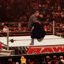 a man in a wrestling ring with the word raw on the floor
