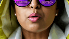 a woman wearing purple sunglasses that say beatbox