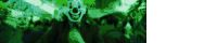 a group of clowns are standing in a dark room in a green light .