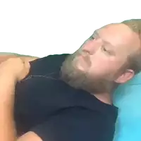 a man with a beard wearing a black shirt