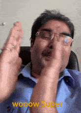 a man wearing glasses and a blue shirt with the words wooow super on the bottom