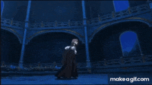 a blurry picture of a clock with a blue background and the words make a gif.com on the bottom .