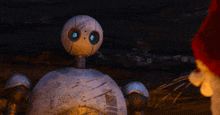 a robot with blue eyes is being held by a person