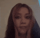 a close up of a woman 's face with long hair .