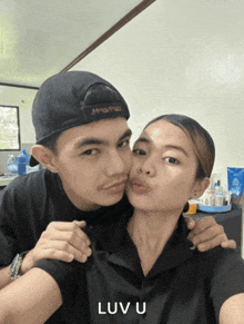 a man kissing a woman on the cheek with the words luv u below