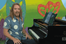 a man in a polka dot shirt is playing a piano