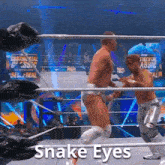 two men are wrestling in a ring with the words snake eyes written on the bottom