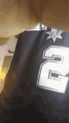 the number 2 is on the back of a black jersey