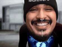 a man with a beard and a nose ring is wearing a black hat that says multiverse