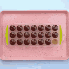 a pink tray filled with chocolate covered cherries
