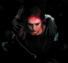 a woman with a crown on her head is being held by a monster .