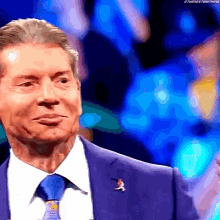 a close up of a man in a suit and tie making a funny face .