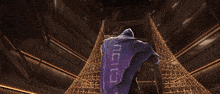 a person holding a gun in front of a large pyramid