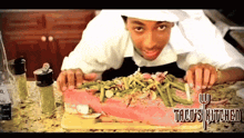 a chef prepares a large piece of meat on a cutting board that says tacos kitchen