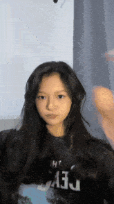 a girl with long hair is wearing a shirt that says dev