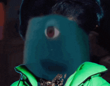 a person in a green jacket has a blue face with a red eye