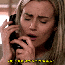 a woman talking on a phone with the words ok fuck motherfucker