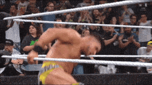 a man in a wrestling ring with the word n on the bottom left