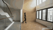a woman walking in a room with the words made in animotica on the bottom right