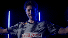 a man wearing a samsung galaxy shirt is making a funny face