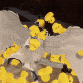 a bunch of yellow rubber ducks are flying around a white bird