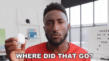 a man in a red shirt is holding a white object in his hand and asking where did that go