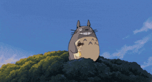 a cartoon drawing of a totoro and a cat