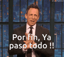 a man in a suit and tie is clapping his hands and says por fin ya paso todo