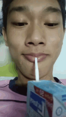 a young man drinking from a carton that says ' mental ' on it