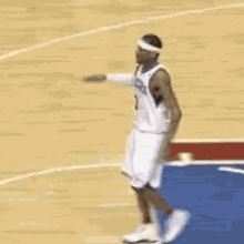 two basketball players hugging each other on the court .