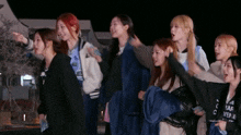 a group of girls are standing in a line with one wearing a shirt that says converse on it