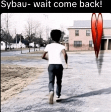 a young boy walking down a street with a broken heart in the background and the caption sybau- wait come back