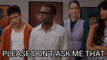 a group of people are standing in a room and a man is standing in the middle of the group .