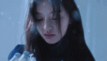 a close up of a woman 's face with snow falling