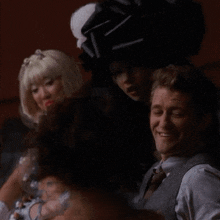 a man and a woman are sitting next to each other in a dark room