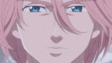 a close up of a person 's face with blue eyes and pink hair
