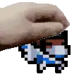 a hand is holding a pixel art piece of a person 's face .
